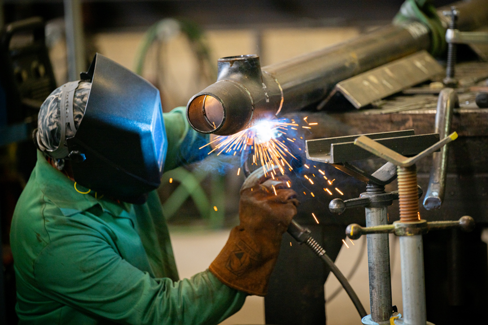 Certified welder performing pipe fabrication for mechanical systems at Herman Goldner Co., Inc., demonstrating precision welding and craftsmanship for industrial projects in Philadelphia.